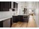 Open-concept kitchen features dark cabinetry, stainless appliances, and an island with seating at 3142 W 26Th Ave, Denver, CO 80211