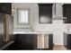 Modern kitchen with sleek stainless steel appliances, dark cabinets, and subway tile backsplash at 3142 W 26Th Ave, Denver, CO 80211