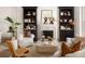 Elegant living room featuring built-in bookcases, a fireplace, and stylish, comfortable seating at 3142 W 26Th Ave, Denver, CO 80211