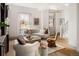 Bright living room featuring hardwood floors, a modern sofa, and plenty of natural light at 3142 W 26Th Ave, Denver, CO 80211