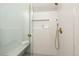 Sleek shower with white mosaic tiling, a built-in bench, and gold-toned fixtures at 3142 W 26Th Ave, Denver, CO 80211