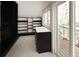 Walk-in closet with custom shelves and drawers, featuring an adjacent outdoor balcony at 3142 W 26Th Ave, Denver, CO 80211
