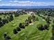 Expansive aerial view of the golf course with lake and mountain views at 5845 W Mansfield Ave # 259, Denver, CO 80235