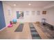 Finished basement gym area with hard flooring and various exercise equipment displayed at 5845 W Mansfield Ave # 259, Denver, CO 80235