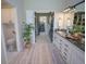 Bright bathroom featuring white cabinetry, granite countertop, modern fixtures and a peek into the laundry room at 5845 W Mansfield Ave # 259, Denver, CO 80235