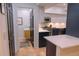 Open-concept kitchen featuring stainless steel appliances and adjoining powder room at 5845 W Mansfield Ave # 259, Denver, CO 80235