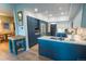 Modern kitchen with blue cabinets, stainless steel appliances and quartz countertops at 5845 W Mansfield Ave # 259, Denver, CO 80235