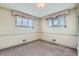 Well-lit bedroom featuring two windows and carpeted floor at 942 Leroy Dr, Northglenn, CO 80233