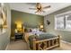 Bedroom with rustic bed frame, green walls, and two bedside tables with lamps at 32094 Christopher Ln, Conifer, CO 80433