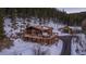 Aerial view of the home and deck, complete with a hot tub and surrounding nature at 32094 Christopher Ln, Conifer, CO 80433