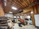 Spacious garage interior with exposed wooden beams, natural lighting, and ample storage space at 32094 Christopher Ln, Conifer, CO 80433
