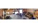 Panoramic garage interior featuring exposed wooden beams, work area, and access to garage door at 32094 Christopher Ln, Conifer, CO 80433