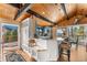 Bright, stylish kitchen featuring blue cabinets, modern appliances, a breakfast bar, and scenic views at 32094 Christopher Ln, Conifer, CO 80433