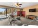 Living room featuring cozy seating, fireplace, wood stove and mountain views through sliding glass doors at 32094 Christopher Ln, Conifer, CO 80433