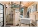 Bright main bathroom featuring walk-in shower, soaking tub, and natural light at 32094 Christopher Ln, Conifer, CO 80433