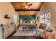 Cozy main bedroom featuring wood ceiling, accent wall, and comfortable furnishings at 32094 Christopher Ln, Conifer, CO 80433