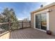 View of the exterior back deck with sliding glass doors and wooden planks at 3971 S Quintero Way, Aurora, CO 80013