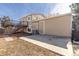 Back of house with stairs to deck and door to home at 3971 S Quintero Way, Aurora, CO 80013