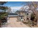 Tan two-story home showcasing solar panels and an attached two-car garage at 3971 S Quintero Way, Aurora, CO 80013