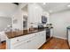 Well-lit kitchen boasts stainless appliances, granite countertops, and white cabinets at 3971 S Quintero Way, Aurora, CO 80013