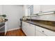 Close-up of kitchen features white cabinets and stunning granite countertops at 3971 S Quintero Way, Aurora, CO 80013