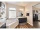 Bathroom featuring a large tub with jets, and double vanity sink at 16650 Shadow Wood Ct, Hudson, CO 80642