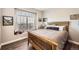 Bedroom with a comfortable bed, natural lighting, and a view of the outside at 16650 Shadow Wood Ct, Hudson, CO 80642