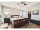 Bedroom features a large bed, a ceiling fan, and a walk-in closet at 16650 Shadow Wood Ct, Hudson, CO 80642