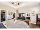 Main bedroom features a large bed and a view of the Primary bath and closet at 16650 Shadow Wood Ct, Hudson, CO 80642