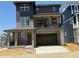 Inviting two-story home with a stone facade, a balcony, and a spacious two-car garage at 6717 E 149Th Ave, Thornton, CO 80602