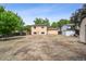 An open backyard shows a storage shed and back of the home at 9366 Clermont Dr, Thornton, CO 80229