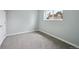 A bright, carpeted bedroom features natural light from a window at 9366 Clermont Dr, Thornton, CO 80229