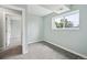 A bright bedroom features a window and view into another room at 9366 Clermont Dr, Thornton, CO 80229