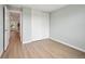 Empty bedroom with sliding closet doors, neutral walls and wood-look flooring at 9366 Clermont Dr, Thornton, CO 80229