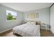 Bright bedroom with a wooden bed frame, plush pillows, and decorative wall art at 9366 Clermont Dr, Thornton, CO 80229