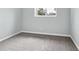 A gray carpeted bedroom features a window for natural light at 9366 Clermont Dr, Thornton, CO 80229