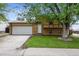 A classic two-story home features an attached two-car garage at 9366 Clermont Dr, Thornton, CO 80229