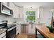 Bright kitchen with stainless steel appliances, granite countertops, and a view to the outdoors at 9366 Clermont Dr, Thornton, CO 80229