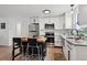 Stylish kitchen boasts stainless appliances, white cabinets, and center island with breakfast bar at 9366 Clermont Dr, Thornton, CO 80229