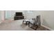 Cozy sitting area in basement living room with comfortable chair and ottoman at 9366 Clermont Dr, Thornton, CO 80229