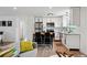 Open floor plan showcases the modern kitchen and comfortable living space with neutral decor at 9366 Clermont Dr, Thornton, CO 80229