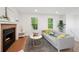 Cozy living room with a fireplace, stylish decor, and plenty of natural light at 9366 Clermont Dr, Thornton, CO 80229