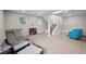 Spacious basement living room with carpeted floor, natural light, and furniture at 9366 Clermont Dr, Thornton, CO 80229