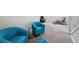 Basement living room with plush blue chairs, carpeted floor, and natural light at 9366 Clermont Dr, Thornton, CO 80229