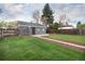 A spacious backyard featuring a well-maintained lawn and a detached garage, all enclosed by a wooden fence at 3320 N Madison St, Denver, CO 80205
