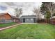 Expansive backyard features lush lawn and a charming, detached structure at 3320 N Madison St, Denver, CO 80205