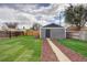 Spacious backyard with well-maintained lawn and stylish detached structure at 3320 N Madison St, Denver, CO 80205