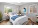 Bright bedroom featuring hardwood floors, light gray walls, and large windows with outdoor views at 3320 N Madison St, Denver, CO 80205