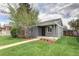 Charming gray bungalow with green lawn, sidewalk, and a mature tree enhancing its curb appeal at 3320 N Madison St, Denver, CO 80205
