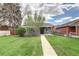 Charming home with a well-kept front yard, featuring a walkway and nicely trimmed bushes at 3320 N Madison St, Denver, CO 80205